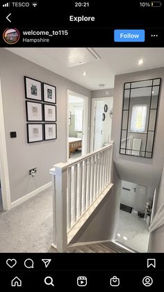 the stairs in this house are white and have black frames on them, along with pictures hanging on the wall