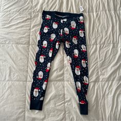 Christmas Pajama Pants From Old Navy. Legging Style. 100% Cotton Fabric Is Soft And Stretchy And Can Be Machine Washed And Dried. Cute Santa Print (These Are The Santas With A Tan)! Size Xl. Brand New With Tags. Waist Is 18.5 Inches Laying Flat And Inseam Is 29 Inches. Casual Christmas Sleep Bottoms, Christmas Cotton Sleep Pants, Cotton Lounge Pants For Christmas, Cotton Pants For Christmas Loungewear, Casual Christmas Bottoms For Sleepovers, Casual Christmas Loungewear Bottoms, Casual Winter Bedtime Bottoms, Casual Holiday Sleepwear With Long Pants, Christmas Cotton Loungewear Bottoms