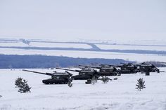 several tanks are lined up in the snow