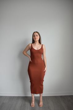 Step up your casual style with our Chic Knit Maxi Dress - Brick. This dress features a warm brick color and soft knit fabric, perfect for brunch with friends, casual weekend outings, or daytime strolls. The maxi length offers a flattering silhouette for effortless elegance. Upgrade your wardrobe with this versatile piece! Elevate any look with the classic style of the Brick knit Maxi Dress. Crafted from ribbed knit fabric, this sweater dress features a sleeveless design, low back neckline detail Brown Ribbed Midi Dress, Spring Brown Ribbed Midi Dress, Casual Ribbed Maxi Dress For Fall, Casual Stretch Ribbed Maxi Dress, Casual Brown Midi Dress For Brunch, Solid Maxi Dress For Fall Brunch, Casual Brown Stretch Maxi Dress, Solid Color Maxi Dress For Fall Brunch, Casual Stretch Brown Maxi Dress