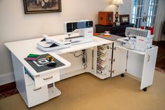 a white desk with sewing machines on it