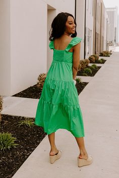 - This sweet dress is perfect for a sunny day! - Lightweight, green hued material with a lined bust - A scoop neckline - A bust with gathered detail - Flutter sleeves with elastic shoulders - A smocked upper back - A relaxed silhouette that ends in a straight midi length hemline Sweet Dress, Flutter Sleeves, Kelly Green, Sunny Day, Hip Length, Flutter Sleeve, Scoop Neckline, Sunny Days, Midi Length