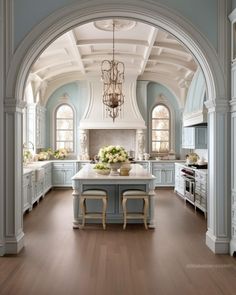 a large kitchen with an archway leading to the dining room and breakfast nooks