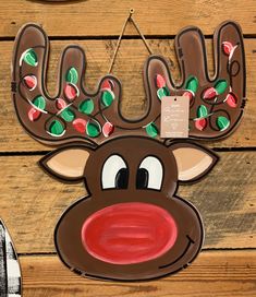 a reindeer head hanging on the side of a wooden wall