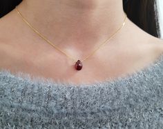 Add a touch of elegance with this handmade necklace, featuring a genuine Garnet gemstone dangling on a simple dainty chain. Choose your length for a choice to wear it as a choker or a long layered necklace. Simple, minimal, and elegant all-in-one necklace. Makes a great gift to add to any gemstone lover's collection. Perfect to gift for Christmas, Valentine's Day, Mother's Day, and more! Gemstone: Garnet Gemstone Size: 11.0 mm Gemstone Shape: Pear, Faceted Metal: 14k Gold Filled or Sterling Silv Dainty Pear-shaped Gemstone Necklace, Minimalist Teardrop Pendant Gemstone Drop Necklace, Minimalist Teardrop Gemstone Drop Necklace, Minimalist Briolette Gemstone Necklace, Minimalist Pear Shaped Necklace With Delicate Chain, Dainty Briolette Drop Necklace As Gift, Dainty Briolette Gemstone Drop Necklace, Minimalist Gemstone Drop Necklace As Gift, Minimalist Briolette Drop Necklace For Gift