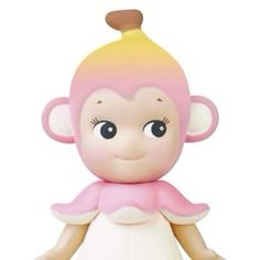 a small toy monkey wearing a pink and yellow dress with big eyes on it's head