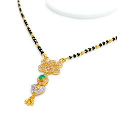 Crafted in 22k yellow gold, this iconic Mangal Sutra weighs 10.5 grams and features a beautiful heart-shaped CZ pendant, complemented by traditional black beads. The 16" necklace includes a 1.5" drop and 1" adjustable links, making it versatile for different necklines. Finished with a secure hook lock, this piece elegantly blends timeless tradition with modern sparkle, creating a heartwarming statement of love and style for any occasion. PRODUCT DETAILS Gold Purity(karat): 22k Item Weight(grams) Festive Black Necklace In 22k Gold, Black 22k Gold Necklace For Weddings, Black 22k Gold Jewelry As A Gift, Black 22k Gold Jewelry Gift, Black 22k Gold Jewelry For Wedding, Black 22k Gold Wedding Jewelry, Mangal Sutra, Different Necklines, 16 Necklace