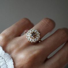 a close up of a person's hand with a ring on it