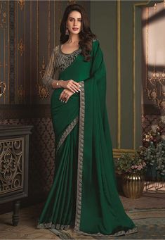 Art Satin Silk Saree in Dark Green This drape is Enhanced with Resham, Zari, Stone and Sequins Work Available with a Semi-stitched Net and Art Silk Blouse in Grey. Crafted in Round Neck and Quarter Sleeve Do note: 1.)Accessories shown in the image are for presentation purposes only. 2.)Slight variation in actual color vs. image is possible. Bollywood Sarees Online, Full Highlight, Satin Silk Saree, Reception Saree, Off White Fashion, Designer Sarees Collection, Sarees Collection, Embroidered Border, Utsav Fashion