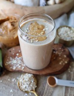 a close up of a drink on a table with cookies and other food items in the background