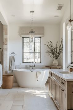 a large white bath tub sitting under a window