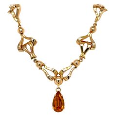 This exquisite vintage necklace exudes a timeless, feminine glamour that harkens back to the retro styles of the 1940s. Finely crafted in luxurious 18k yellow gold, it showcases a warm, rosy tone characteristic of antique gold pieces from that era. The necklace measures 17 inches in length and weighs approximately 19 grams, blending delicacy with meaningful weight and presence. The necklace's front is adorned with an ornate series of fancy articulated links, forming an alluring garland-like patt 1940s Necklace, Spessartite Garnet, Retro Styles, Delicate Details, Retro Stil, Vibrant Orange, Style Retro, Necklace Designs, Gemstone Colors