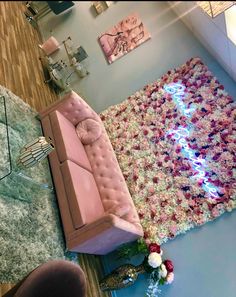 a living room with pink couches and rugs on the floor in front of it