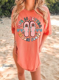 "Discover our Sun-Kissed Comfort Color Shirts, the ultimate summer wardrobe essential, designed to enhance your beach vibes and create unforgettable summer memories! Featuring a range of eye-catching designs inspired by sun-soaked beaches, tropical paradise, and endless summer adventures, our shirts will have you daydreaming about your next beach escape. Dive into a world of surf, sand, and salty sea breeze with our vibrant collection of t-shirts that embrace the aloha spirit and coastal living Fun Summer T-shirt With Text Print, Casual Beach T-shirt For Warm Weather, Casual Pre-shrunk T-shirt For Beach, Spring Vacation T-shirt With Crew Neck, Summer Orange Cotton Shirt, Orange Cotton Summer Shirt, Cotton T-shirt For Summer Vacation, Casual Orange Shirt For Summer, Beachy Summer T-shirt With Funny Print