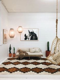 a living room filled with furniture and hanging lights