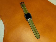 Apple Watch Strap with Rubber Backing Leather watch bands are always in style, their appearance is timeless and considered to be a classic. This apple watch strap, crafted from Italian leather, boasts a remarkable feature: a rubber backing that renders it suitable for use during sports activities. It's very comfortable to wear and easily shapes to your wrist after a short time of regular wear. To add a touch of visual appeal, the watch strap has contrasting white stitching. It's available for al Green Leather Modern Watch Accessories, Modern Green Leather Watch Accessories, Green Leather Watch Accessories For Business, Modern Green Watch Accessories For Everyday Use, Green Leather Business Watch Accessories, Business Green Leather Watch Accessories, Green Leather Watch Bands For Everyday Use, Classic Green Leather Watch Band, Modern Green Rectangular Apple Watch Band