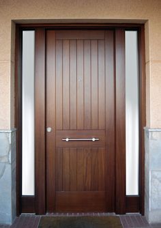 the front door is made of wood and has two sidelights on each side,