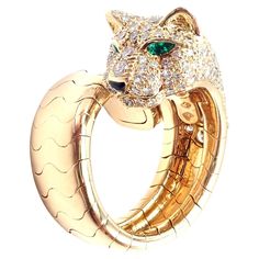 18k Yellow Gold Diamond, Emerald, Onyx Panther Ring by Cartier. Part of Cartier's "Panthere" Collection. With Round brilliant cut diamonds VVS1 clarity, E color total weight approx. 1.50ct. This ring comes with an original Cartier box. Details: Ring Size: European 49 US 4 3/4 The ring is flexible can fit finger size 6. Width: 21mm Weight: 20.1 grams Stamped Hallmarks: Cartier 750 49 819XXX (serial number omitted) *Free Shipping within the United States* YOUR PRICE: $32,500 T3332othdd Cartier Panther Ring, Cartier Panther, Panther Jewelry, Panther Ring, Alexis Bittar Jewelry, Expensive Jewelry Luxury, Cartier Panthere, Jewelry Bracelets Gold, Cartier Jewelry