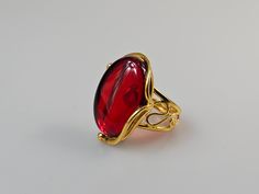 Red Amber ring, ruby red Baltic Amber. Gold plated adjustable ring. Easy resize just by pressing it. Oval shape red ring.  Small  gift Idea.  Gemstone size 2,8 × 2 cm Weight 8,16 gr Handmade of processed genuine yellow amber. Painted gemstone.