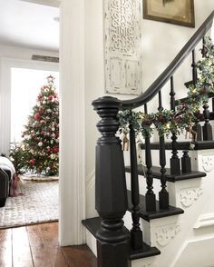 a christmas tree sitting on top of a wooden banister