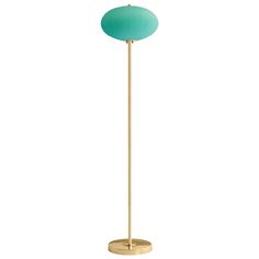 a gold floor lamp with a blue ball on the top and a light green shade