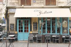 an outdoor cafe with tables and chairs outside