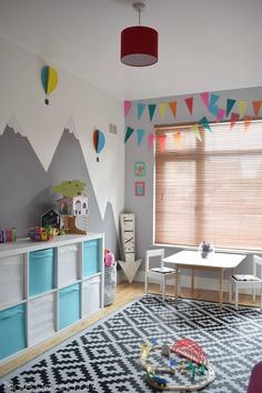 a child's playroom with toys and decor