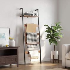 a living room filled with furniture and a potted plant on top of a table