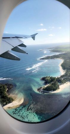 an airplane window looking out at the ocean