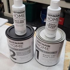 two cans of paint sitting on top of each other