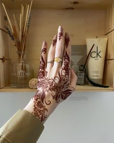 a woman's hand with henna on it