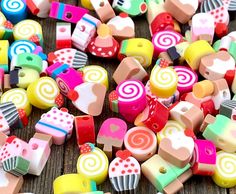 many different colored candies on a wooden table