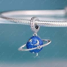 This is charm only, bracelet is sold separately. This beautiful enamel blue planet pendant charm is made of solid 925 sterling silver and enamel color, features 3D blue planet with moon and star. This planet dangle charm will fit original bracelet or wear as a pendant for necklace. Experience the wonder of the universe with our stunning Blue Planet pendant charm! Crafted from solid 925 sterling silver and vibrant enamel, this charm showcases a 3D blue planet adorned with a glowing moon and star. Silver Star Charm Celestial Charms, Silver Star Charm Celestial, Silver Celestial Star Charm, Silver Star Charm With Celestial Style, Celestial Silver Jewelry With Charms, Silver Dangle Moon Charm, Celestial Sterling Silver Jewelry With Dangling Charms, Celestial Jewelry With Dangling Charms In Sterling Silver, Space-themed Sterling Silver Jewelry Gift