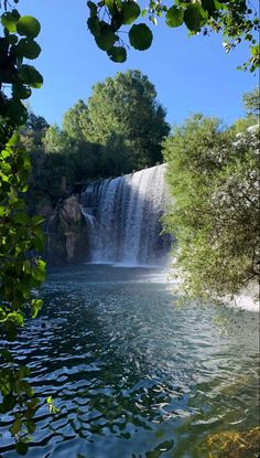 a large waterfall in the middle of a lake