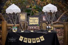 a table topped with two white umbrellas and pictures