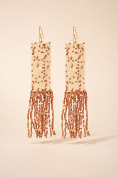 These earrings feature a rectangular beaded design that showcases intricate patterns and vibrant colors, reflecting the traditional Native American craftsmanship. The tassel detail adds movement and texture to the earrings, creating a playful and bohemian vibe. The hook closure ensures easy wear and a comfortable fit. Size Height: 4.25 in (10.8 cm)Width: 0.75 in (1.91 cm) Quality Made using sparkling high quality clear Austrian crystal rhinestones for the most dazzling sparkle, laid on a lightweight strong gold color metal alloy, with a thick, non-slip rubber backing to hold your earrings in place. ImportedE12365 Bohemian Brown Beaded Earrings For Party, Bohemian Rectangular Jewelry For Summer, Bohemian Rectangular Summer Jewelry, Traditional Beaded Tassel Earrings For Summer, Bohemian Rectangular Beaded Earrings With Dangling Beads, Traditional Beaded Fringe Earrings For Summer, Traditional Tassel Drop Beaded Earrings, Bohemian Square Beaded Jewelry, Bohemian Festive Beaded Tassel Earrings