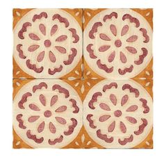 four square tiles with red and white designs on the top, one is made out of ceramic