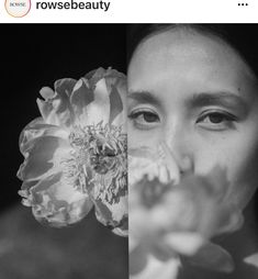 a black and white photo of a woman holding a flower