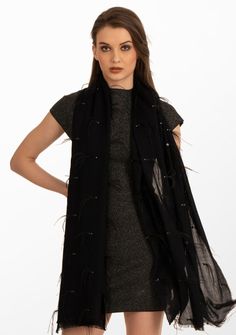 This black scarf is woven from the finest premium cashmere. It is a stunning head-turner adorned with a combination of black ostrich feathers, black sequin and contrasting silver Swarovski crystals scattered across the scarf. Meticulously hand crafted, this scarf is a classic combination of luxury and sophistication. The ostrich feathers add opulence, whilst the scattered sequin and Swarovski crystals bring a subtle yet dazzling allure. Whether draped casually for everyday chic or worn on specia Black Sparkly Scarf, Luxury Black Scarf For Fall, Luxury Black Winter Scarves, Elegant Fringed Scarves For Fall, Elegant Black Winter Scarves, Elegant Evening Scarves For Winter, Elegant Evening Scarf For Winter, Elegant Winter Evening Scarves, Luxury Black Scarf For Formal Occasions