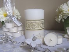 several white candles are sitting on a table