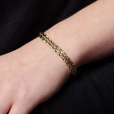 This vintage bracelet (circa 1980-1990) features woven links of 14k gold. The inside is marked 'AK14K' and 'Turkey'. The large piece measures 0.3 inches wide by 10 inches long and is in great condition. Given the length, it can be worn as either a bracelet or ankle bracelet. It can also be shortened upon request. Materials: 14k gold. Formal Gold Braided Jubilee Bracelet, Formal Gold Braided Jubilee Style Bracelet, Formal Gold Bracelet With Wheat Chain, Woven Bracelet, A Bracelet, Vintage Bracelet, Woven Bracelets, Ankle Bracelet, Find Beauty