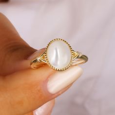 This Mother of Pearl ring will be a perfect gift as a christmas for your best friend.This ring with made of gold plated 18 karat .925 sterling silver. The mother-of-pearl stone is known as the stone of courage and fertility. It creates earth energy, which creates the energy it collects. It helps blood formation and is good for anemia. It is a stone that clears toxins from the body.Minimalist Mother of Pearls will be a best gift idea for your mom or your loved ones as a birthday gift or anniversa Delicate White Gold Crystal Ring As Gift, Gold Plated Round Midi Rings As Gift, Gold Plated Midi Rings For Gift, Gold Crystal Ring With Simple Design, Dainty Pearl Ring With Simple Design For Gift, Dainty Pearl Ring With Simple Design, Elegant Midi Rings With Simple Design For Gift, Delicate Simple Design Birthstone Ring Gift, Gold Plated Pearl Ring As A Gift