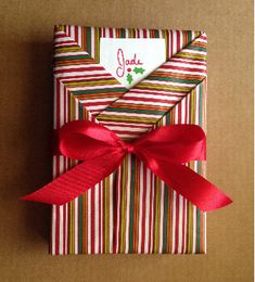 a gift wrapped in red and green striped paper