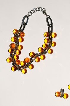 A chunky, linked statement necklace punctuated with amber colored beads. About 19" long including the clasps. Bold Orange Party Jewelry, Chunky Beaded Necklace, Saturn Necklace, Chunky Bead Necklaces, Bead Necklaces, Chunky Beads, Amber Color, Jewelry Watches, Amber