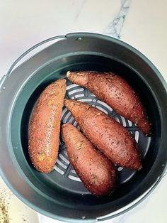 there are four carrots that have been cooked in the pot on the stove top