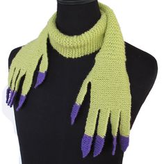 a green and purple scarf on top of a mannequin