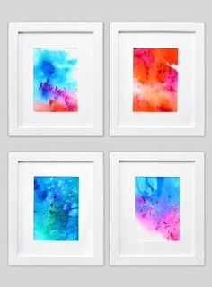 four watercolor paintings in white frames on a gray background, each with different colors