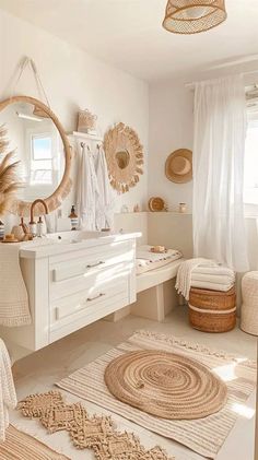 a white bathroom with lots of natural accessories on the counter and rugs around the sink