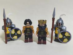 three lego knights standing next to each other