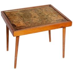 a small wooden table with a map on it's top and legs in front of a white background